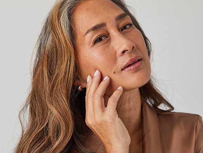 Picture of a model touching the side of their face