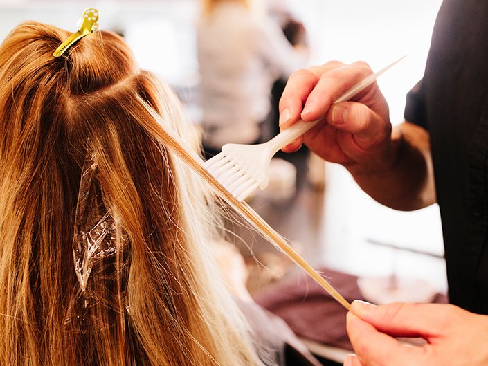 Picture of someone coloring a person's hair