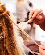 Picture of someone coloring a person's hair