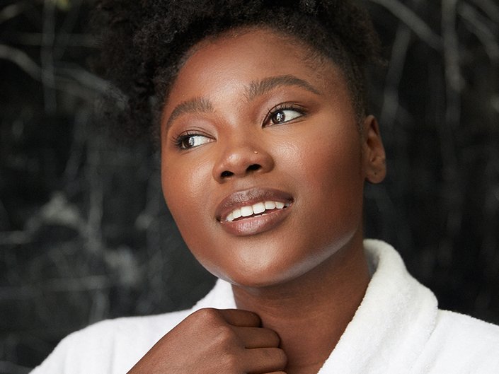 photo of person with clear skin grabbing robe collar