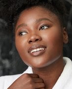 photo of person with clear skin grabbing robe collar