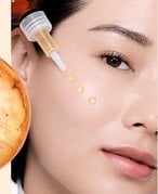 A woman applying face serum to skin