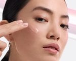 A person applying retinol to face
