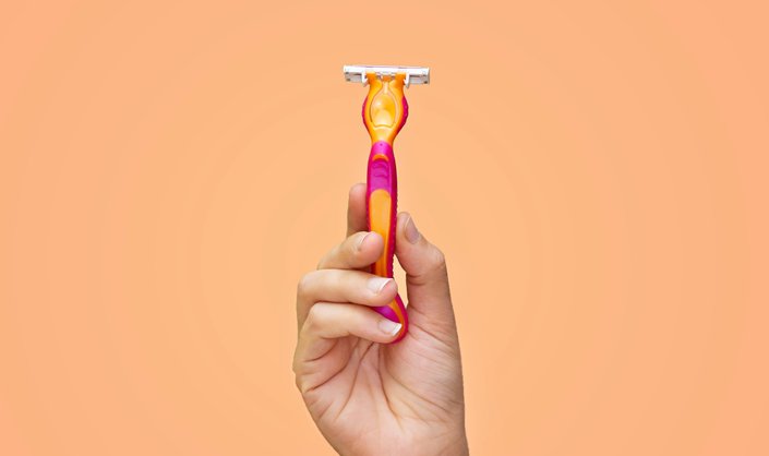 person holding shaving razor